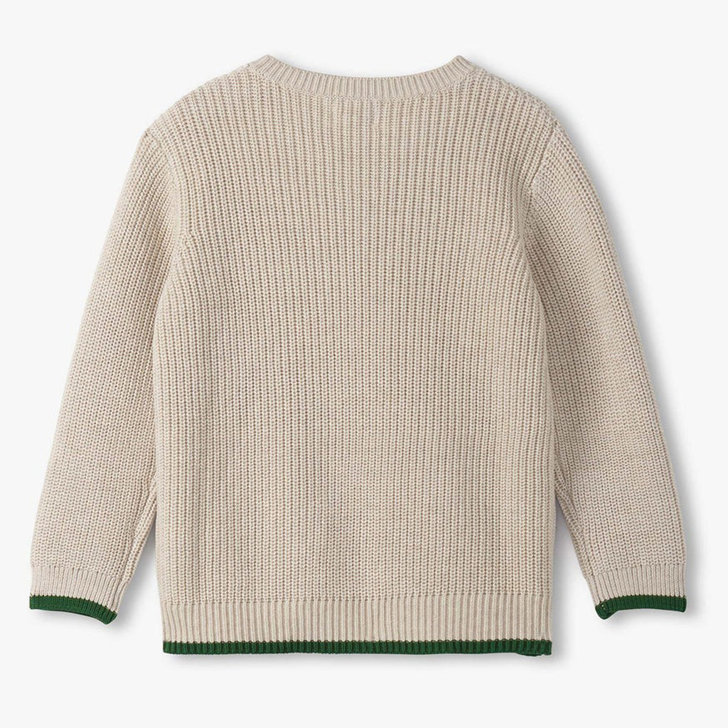 Beige sweater with green trim on a white background