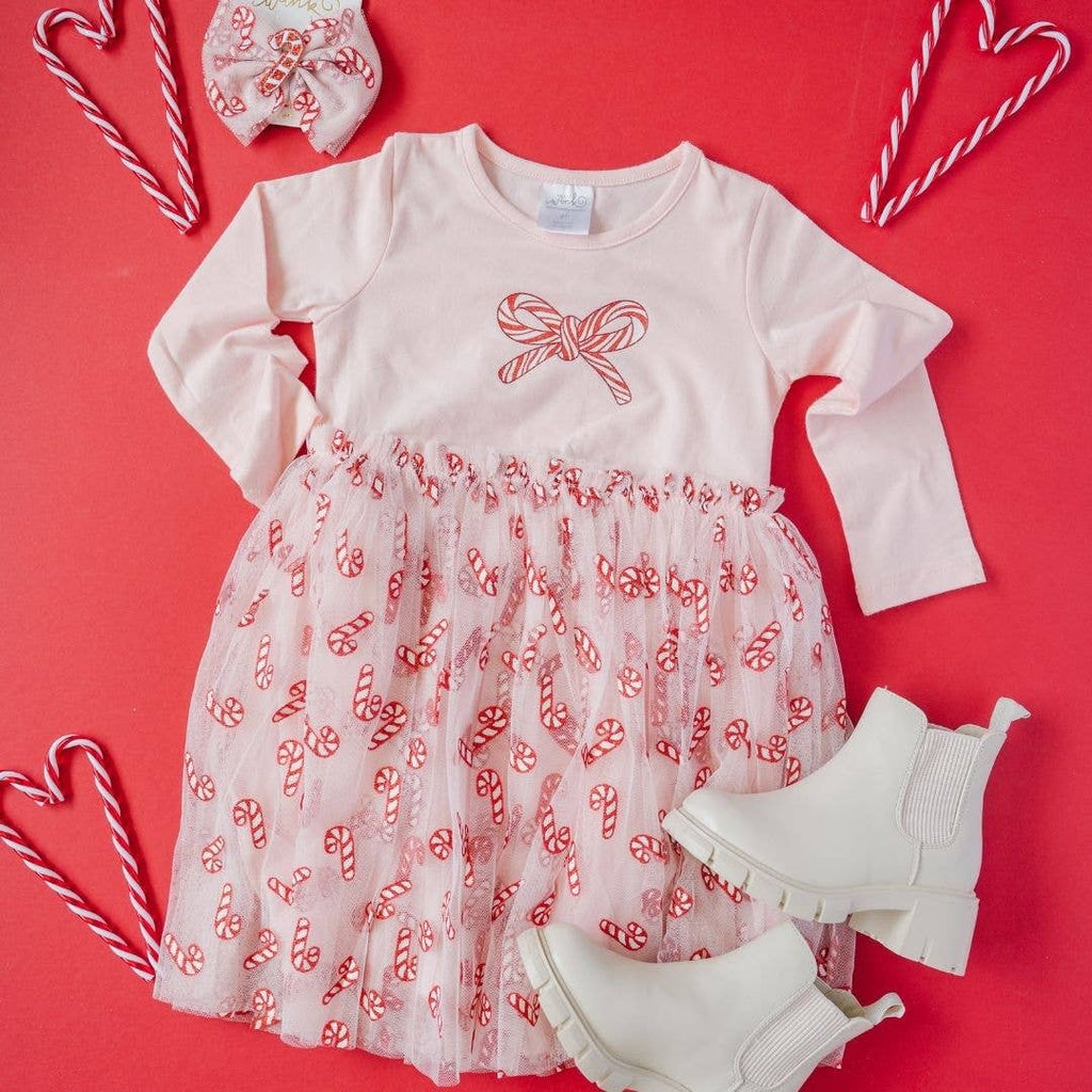 Children's dress with candy cane pattern on a red background