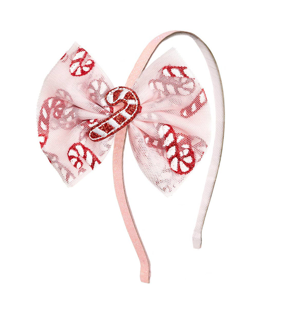 Headband with pink bow and candy cane design on a white background