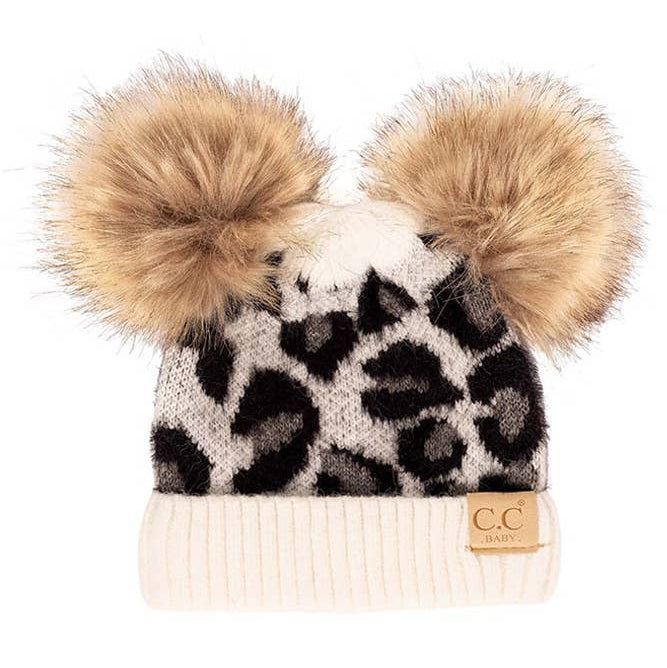 Leopard print beanie with double pom-poms on a white background