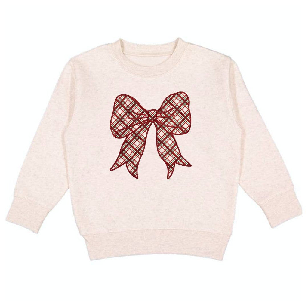 Beige sweater with a red plaid bow design on a white background