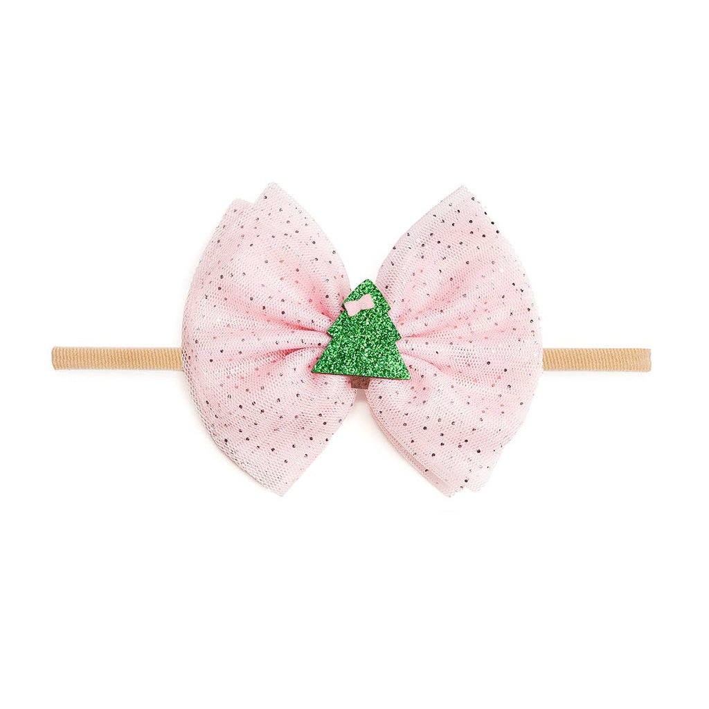 Pink polka dot bow headband with a green Christmas tree on a white background