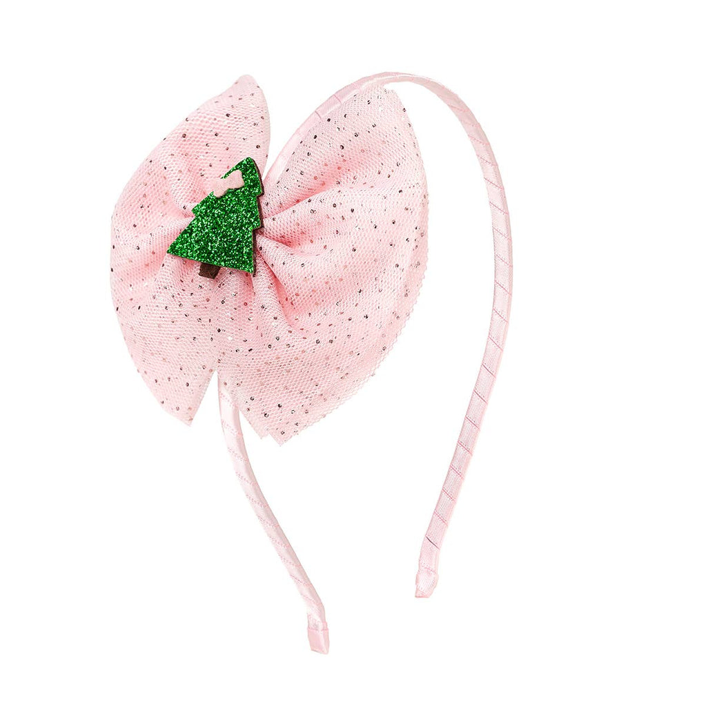 Pink headband with a large bow and green glittery center on a white background