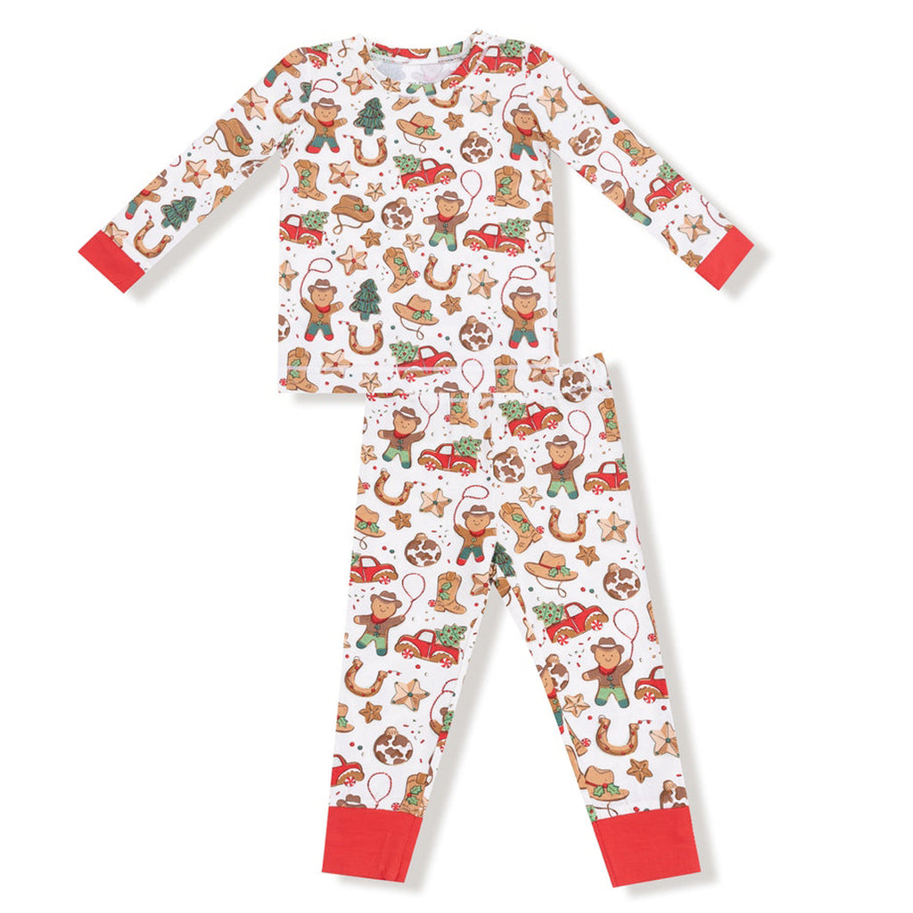 Children's pajama set with gingerbread man and cowboy pattern on a white background
