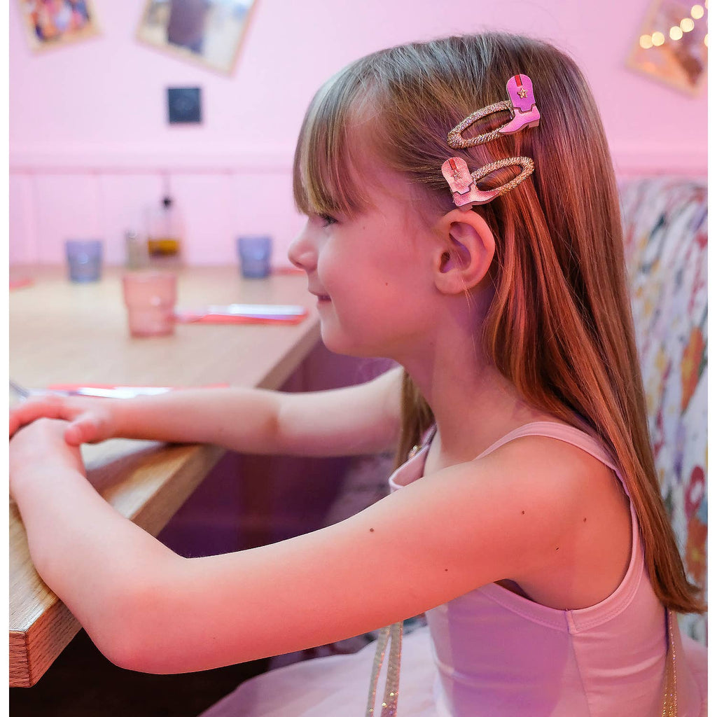 Young girl with a hair clip sitting at a table in a classroom setting