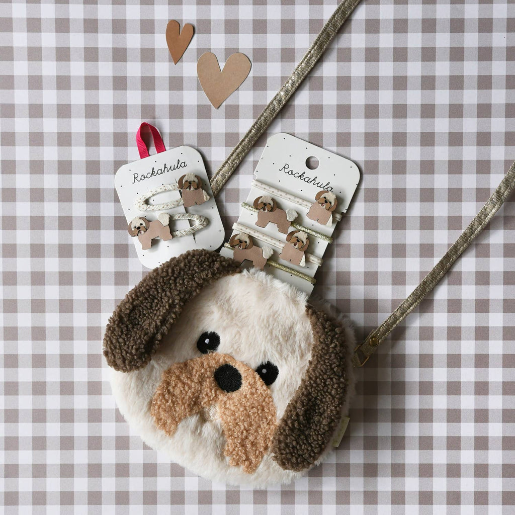 Dog-shaped hair clip and heart-shaped hair clips on a checkered background