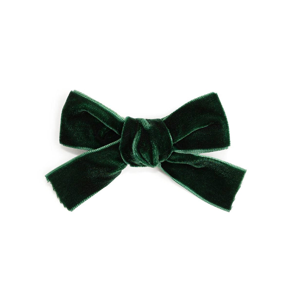 Green velvet bow on a white background