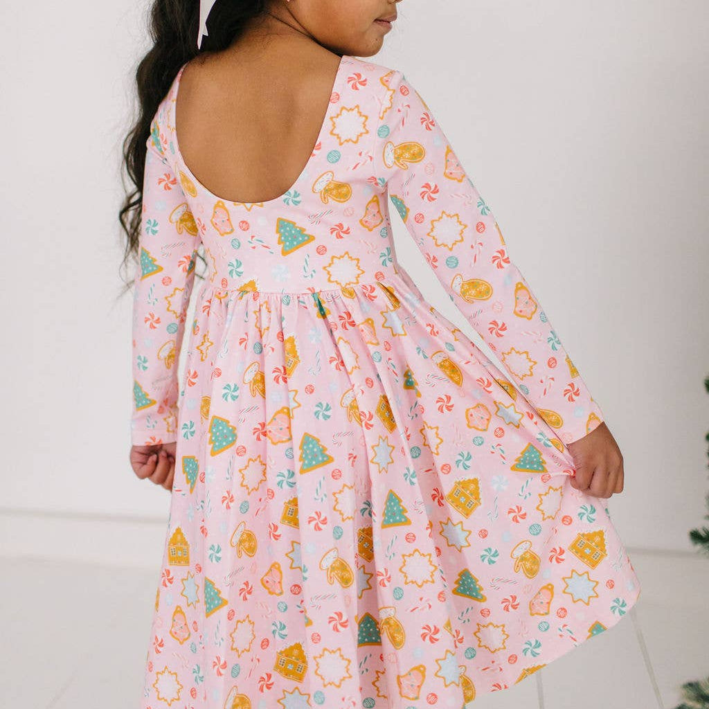 Young girl wearing a colorful dress with a white background