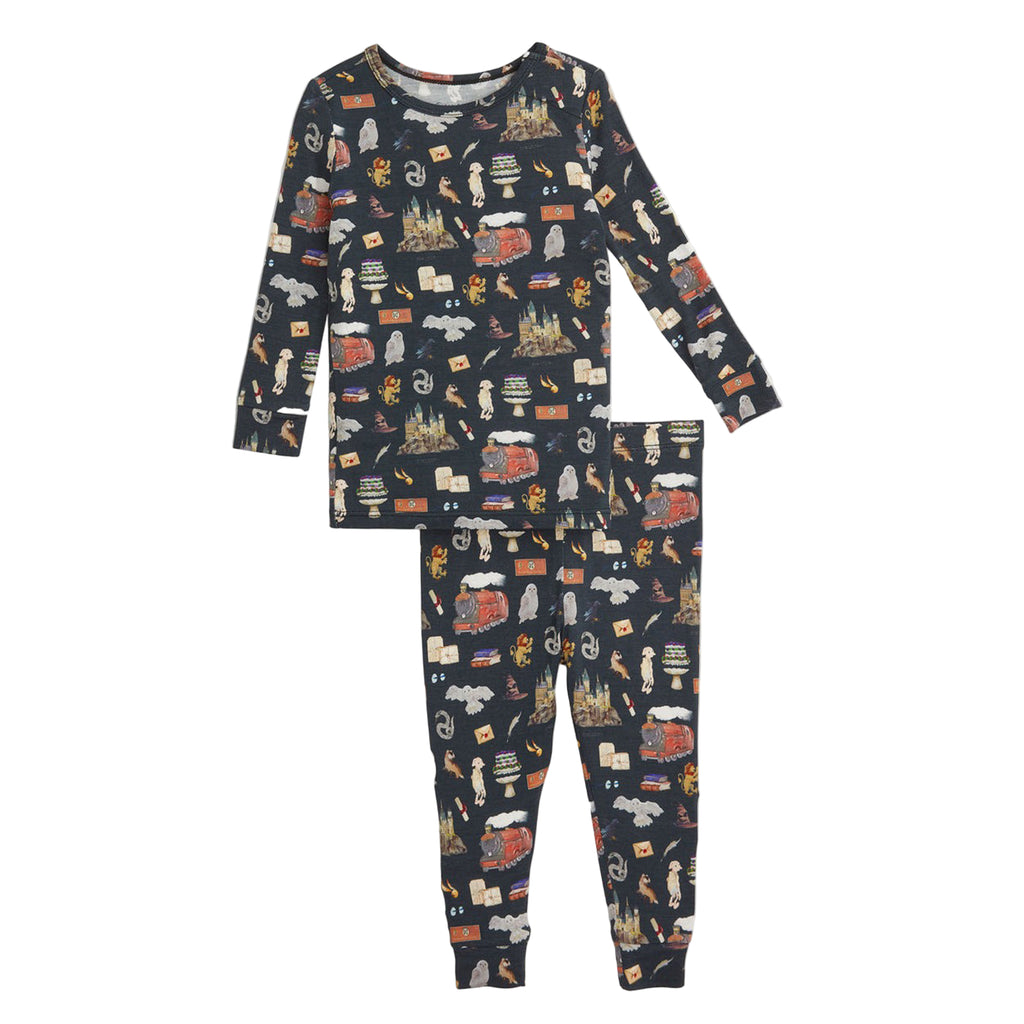 Children's pajama set with a pattern of various objects on a navy background.
