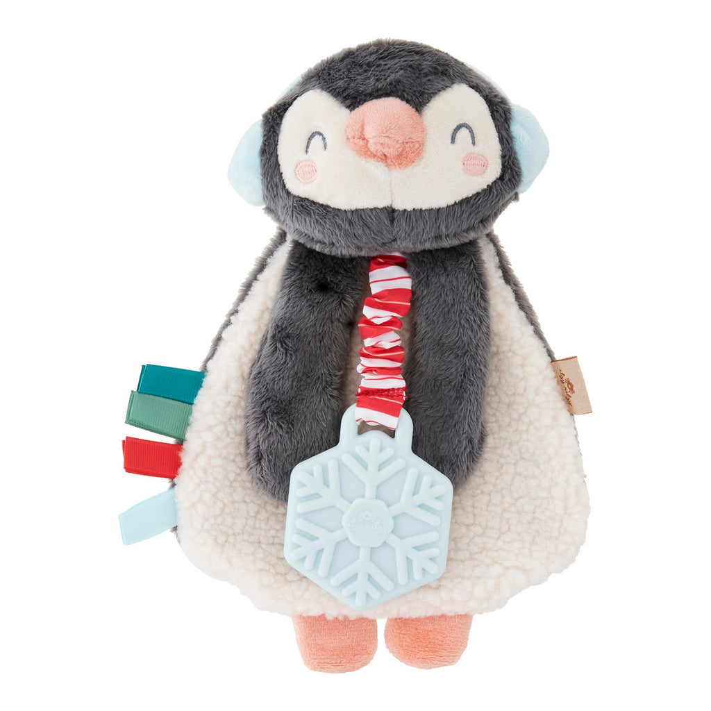 Plush penguin toy with a colorful scarf and snowflake rattle on a white background