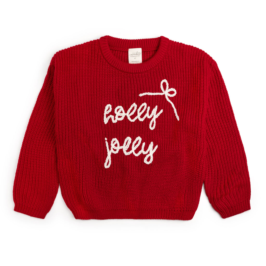 Red sweater with 'holly jolly' text on a white background