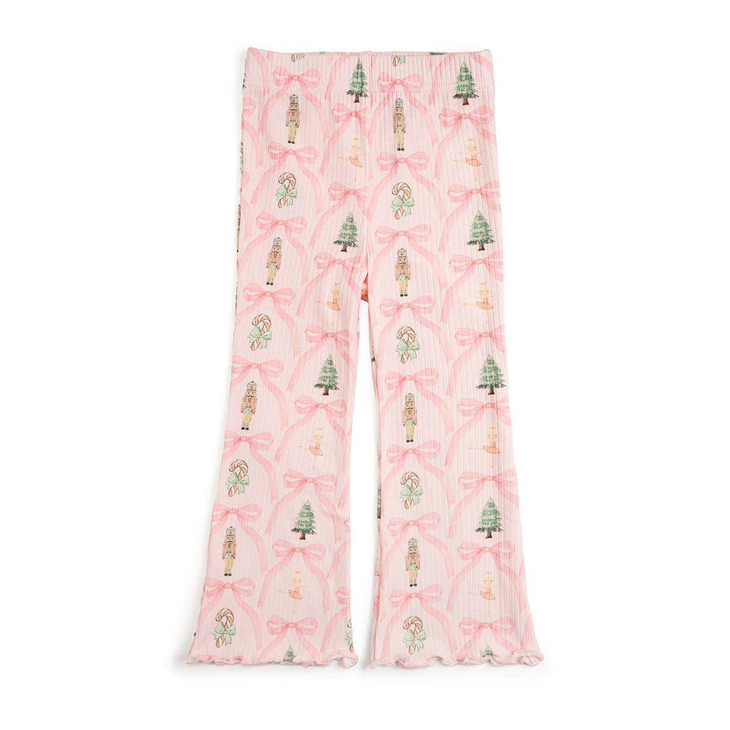 Pink pajama pants with festive pattern on a white background