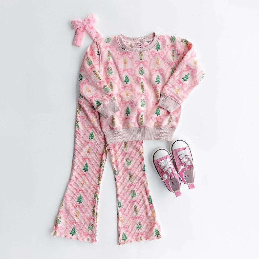Pink children's outfit with matching headband and shoes on a white background