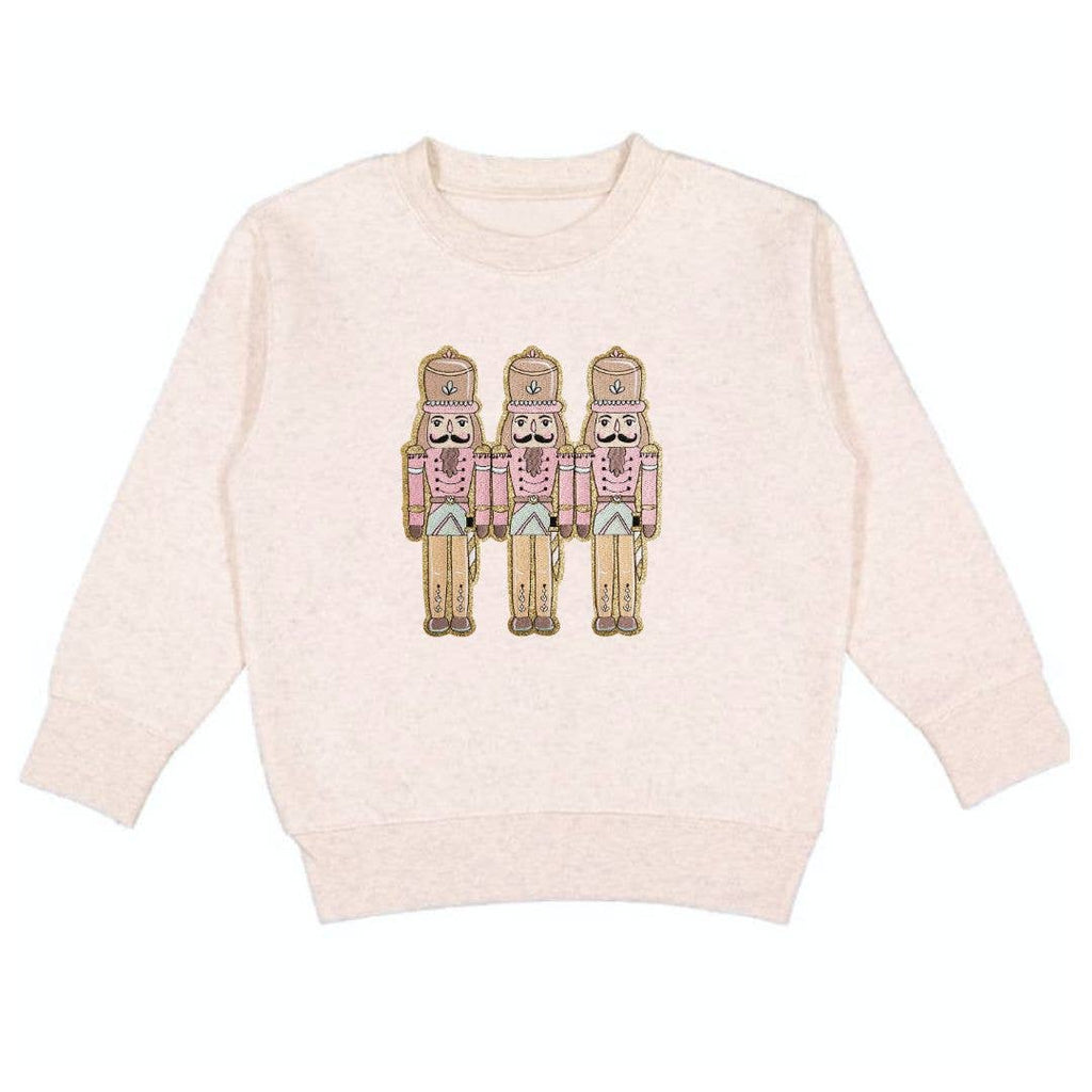 Pink sweater with nutcracker design on a white background