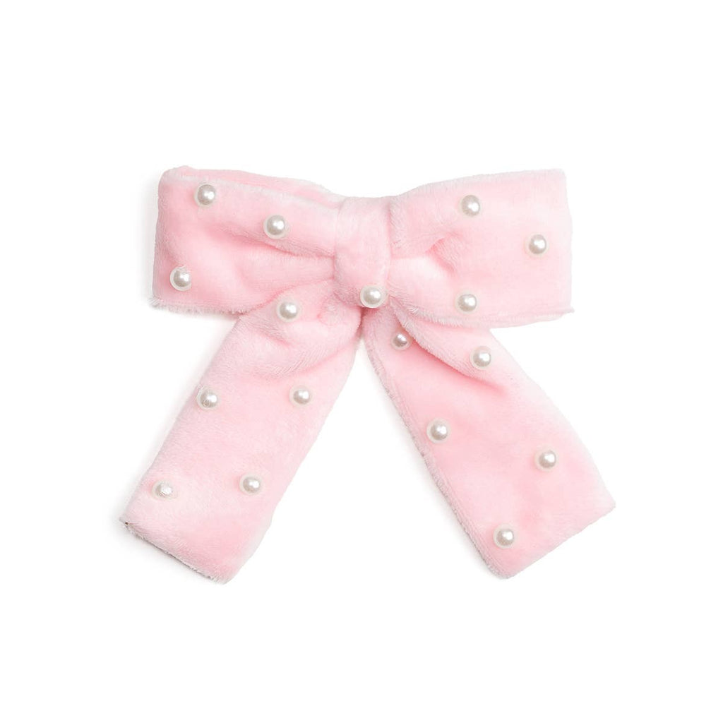 Pink bow with pearl embellishments on a white background