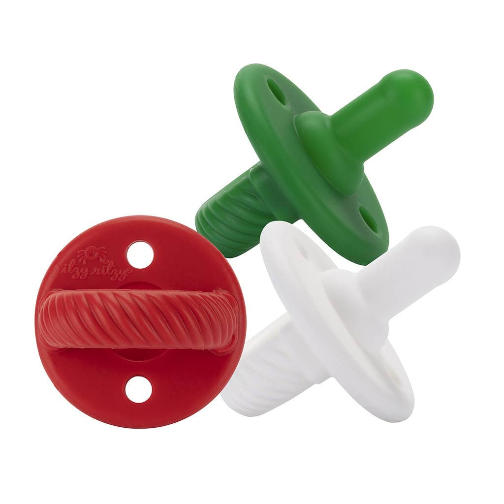 Three colorful pacifiers (green, red, white) on a white background